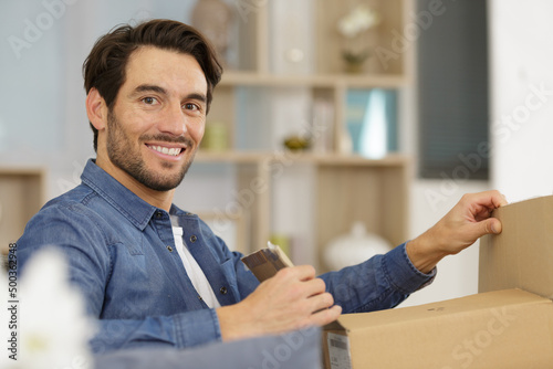 man opening cardboard box