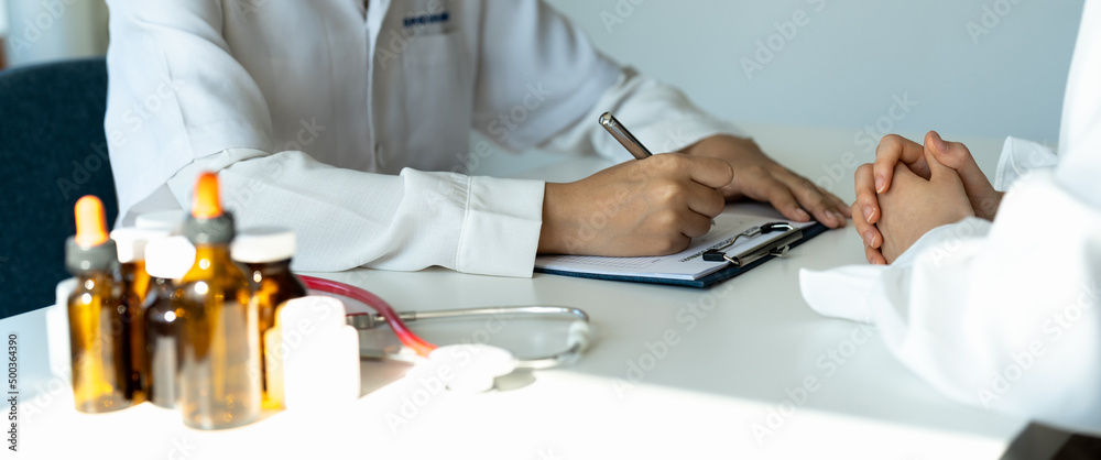 Female doctor giving pills bottle to patient in clinic. Concept of healthcare, medical treatment and insurance Female doctor giving pills bottle to patient in clinic. Concept of healthcare, medical treatment and insurance