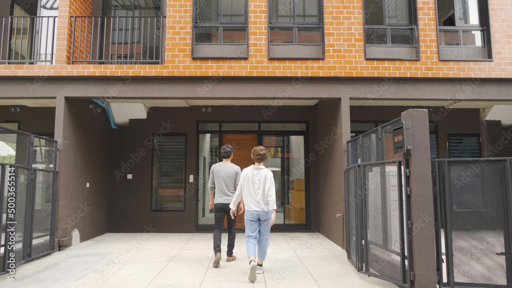 A happy couple moving to their new home or house. Housewarming, Real Estate. People