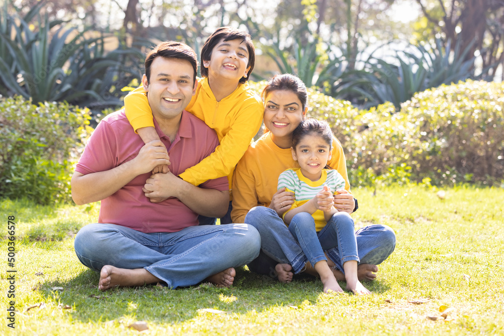 Portrait of happy Indian family spending leisure time at park