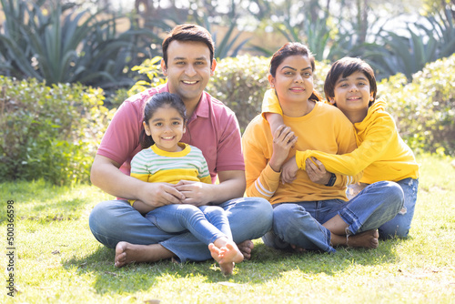 Portrait of happy Indian family spending leisure time at park © G-images