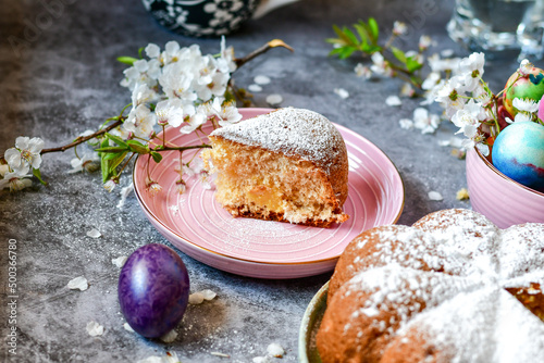 Homemade Italian style Easter bread cake, spring blossom and hand colored eggs. Homemade pastry. Easter holiday baking and decorarion