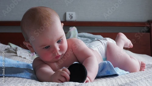 blue toothbrush teether for newborn babies in the baby's mouth holds hands