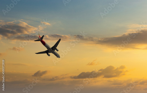 Aircraft flyingon a sunset background