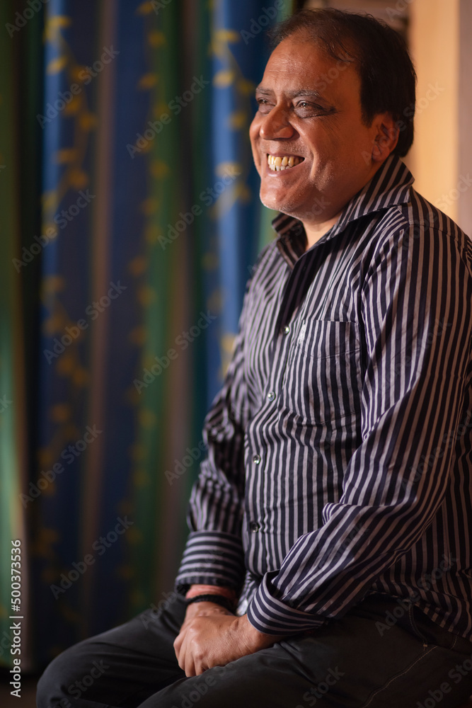 Portrait of a happy senior man sitting at home Portrait of a happy senior man sitting at home