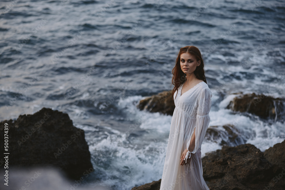 Woman in white wedding dress wet hair rocky stones Woman in white wedding dress wet hair rocky stones