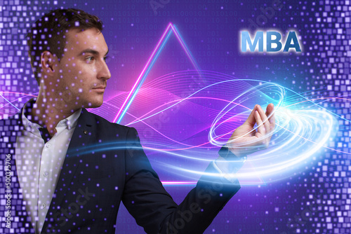 Business  Technology  Internet and network concept. Young businessman working on a virtual screen of the future and sees the inscription  MBA