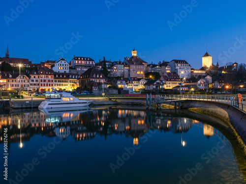 Murten, Switzerland - March 24.2022: Blue hour townscape of medieval Murten or Morat, a bilingual municipality in the lake district of the canton of Fribourg.