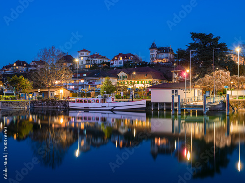 Murten, Switzerland - March 24.2022: Blue hour townscape of medieval Murten or Morat, a bilingual municipality in the lake district of the canton of Fribourg.