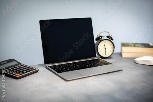 Desktop computer screen on gray desk, interior of working room, work from home. home interior of open work space with white desk. packing parcel box for online shipping delivery. small home business.