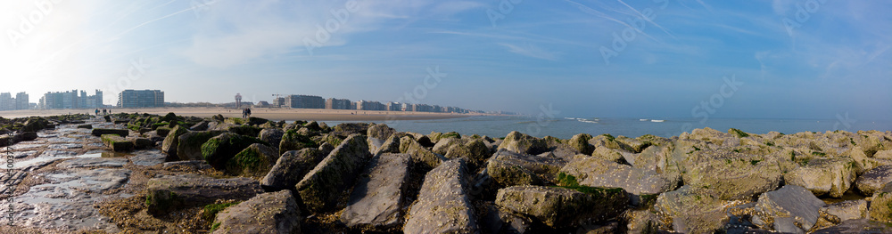 panoramic view from breakwater on a misty spring morning on the beach and apartment buildings