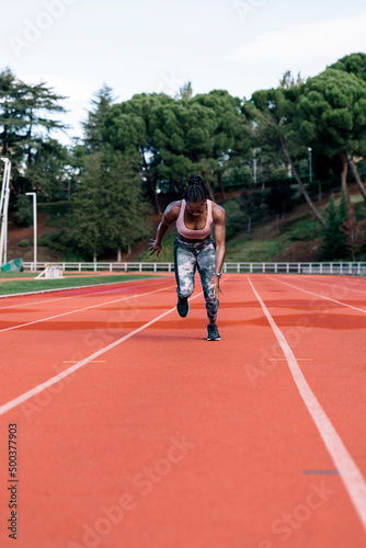 Young black athlete sprinter running © santypan