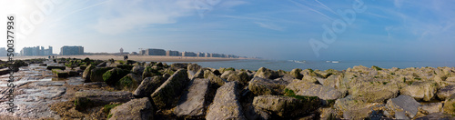 panoramic view from breakwater on a misty spring morning on the beach and apartment buildings