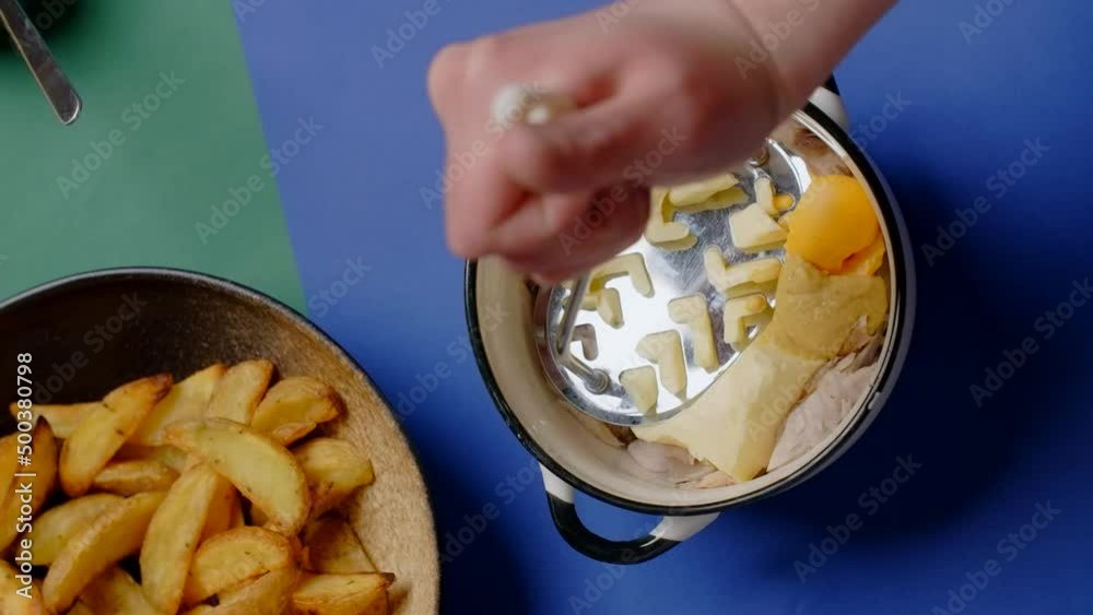 Vertical flat lay food video: chef mashes ingredients and cooks fish pate