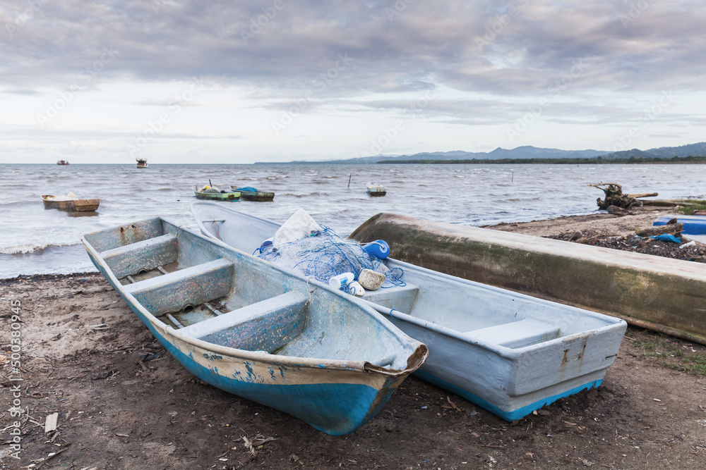 Fototapeta Small boats lay on the coast of Samana Bay