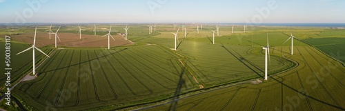 Aerial drone. Wind farm in the fields in south east England. Wind turbines near Camber Sands and Rye, East Sussex. photo