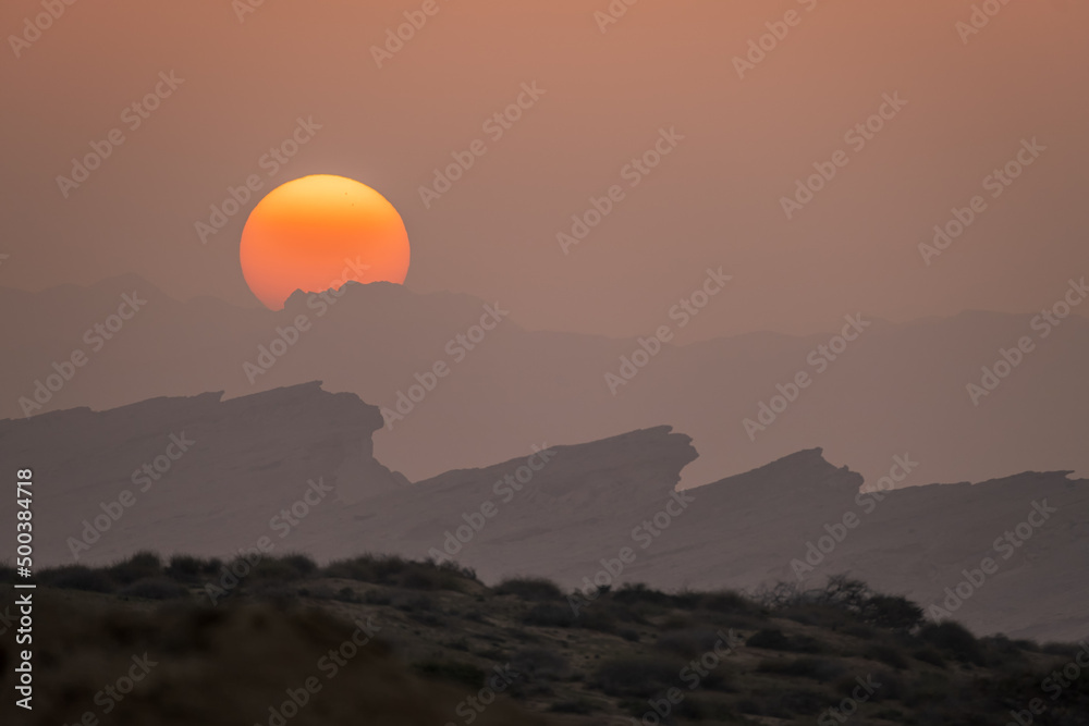 On the island of Qeshm Iran a great sun setting behind the mountains