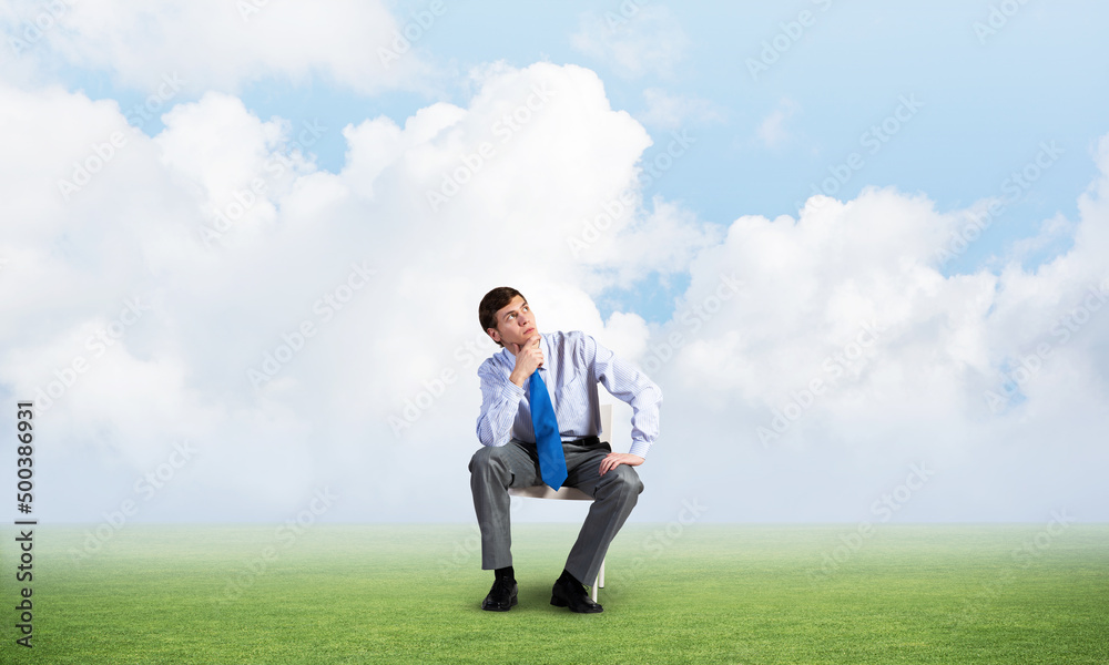 Young businessman sitting on an office chair Young businessman sitting on an office chair
