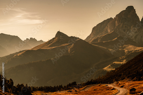 Majestic landscape of Alpine red autumn Passo pardoi. Wonderful hiking nature scenery in dolomite. Sella group, view from Pordoi pass. Dolomites mountains, Italy, Europe. photo