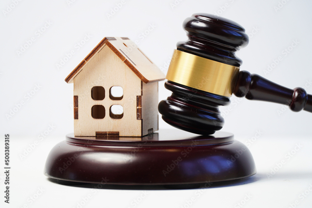 Wooden model of a house with a judge's gavel. The concept of judicial property cases. Wooden model of a house with a judge's gavel. The concept of judicial property cases.