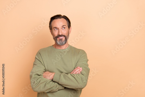 Portrait of attractive cheerful man folded arms making decision copy space isolated over beige pastel color background