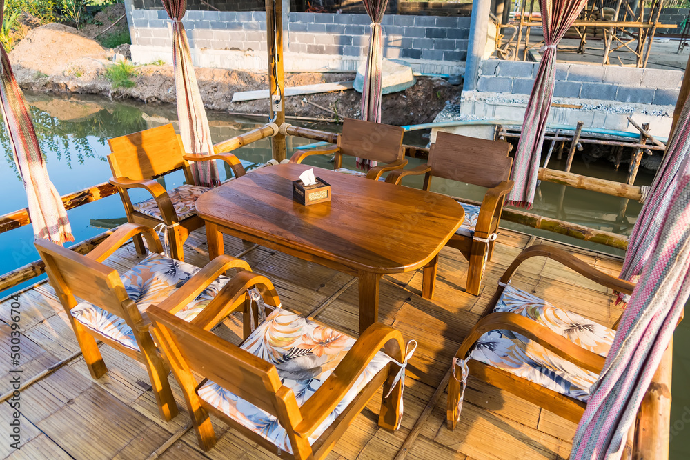 Fototapeta premium Empty table and chair decoration in restaurant interior