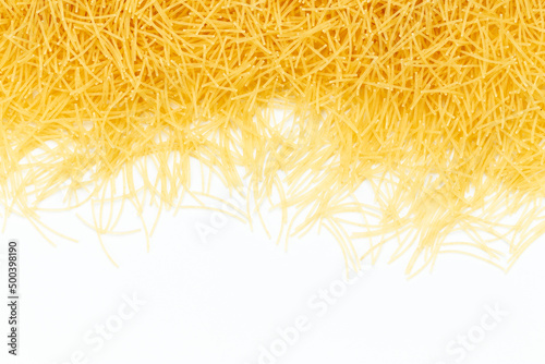 Uncooked vermicelli pasta on white background. Raw dry filini vermicelles.