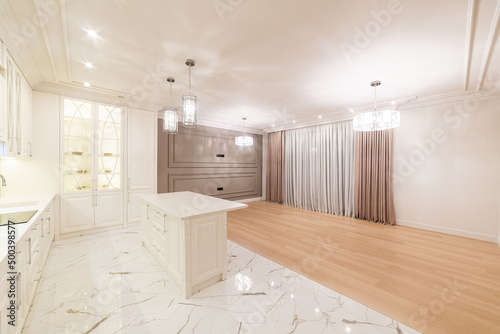 interior of a bright kitchen Studio with tiled wood with white furniture