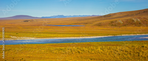Panorama image of a tundra landscape in autumn colors with river  North Slope  Alaska