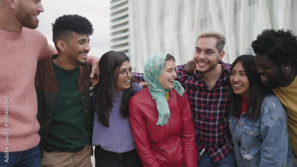 Young multiracial friends having fun together hanging out in the city - Friendship and diversity concept Young multiracial friends having fun together hanging out in the city - Friendship and diversity concept