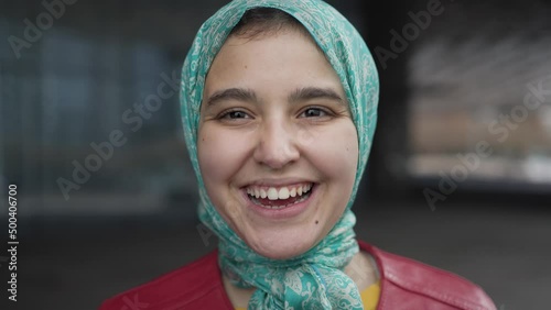 Happy Muslim girl smiling in camera