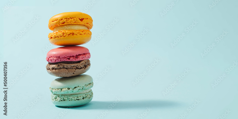 Cake macaron or macaroon on turquoise background from above, colorful almond cookies, pastel colors, vintage card. Cake macaron or macaroon on turquoise background from above, colorful almond cookies, pastel colors, vintage card.