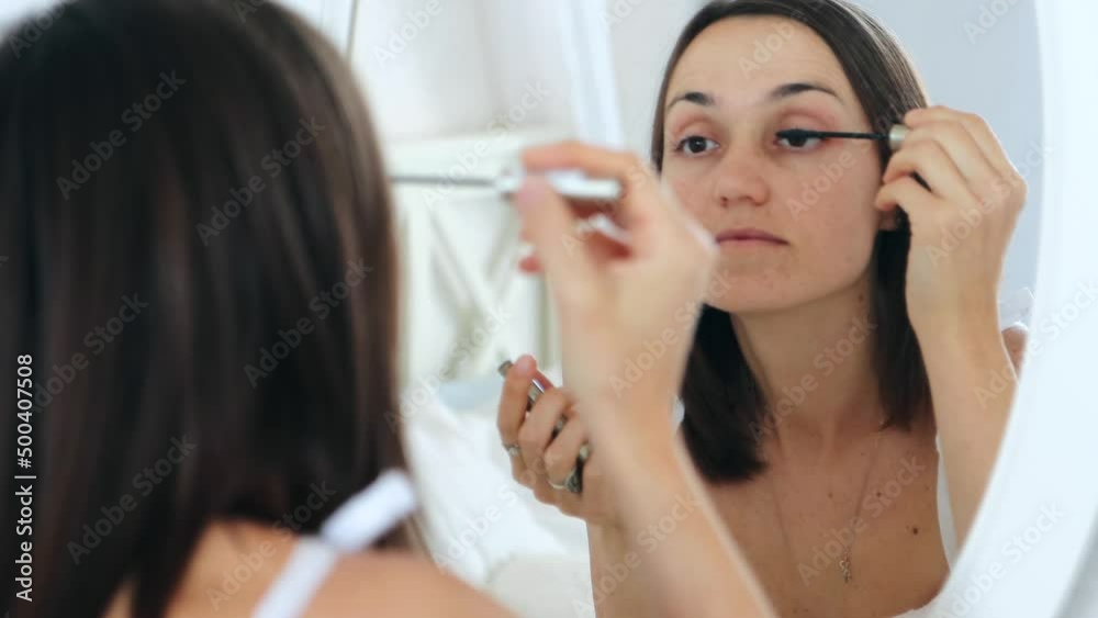 Portrait of pretty 30s caucasian woman applying eyelashes mascara makeup, view in mirror reflection, close-up 4k Portrait of pretty 30s caucasian woman applying eyelashes mascara makeup, view in mirror reflection, close-up 4k