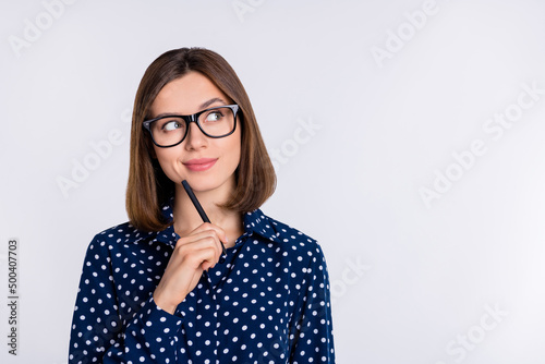 Portrait of attractive curious cheery girl thinking deciding copy space guess isolated over grey pastel color background
