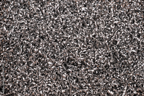 Silver pieces of metal and steel filings photographed in close-up macro in a metal factory