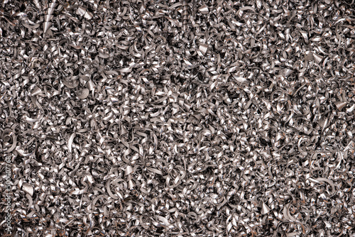 Silver pieces of metal and steel filings photographed in close-up macro in a metal factory