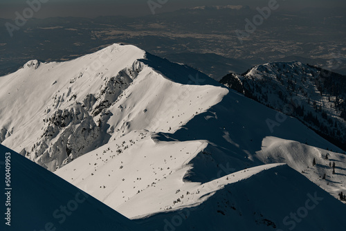 beautiful aerial view of the snow-capped mountain range and winter mountain landscape