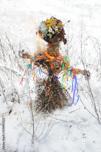 Marzanna (Morė, Marena, Mara, Morana, Morena, Mora) effigy (doll, puppet) made from straw and burned and drowned in a river around spring equinox in celebration of end of winter as a ancient tradition photo