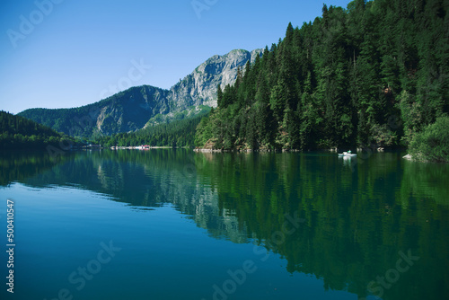 Fototapeta Naklejka Na Ścianę i Meble -  Magnificent view of the summer of the lake in the morning in the rays of the sun. Type of lake in the mountains of the Caucasus. Wildlife during sunrise. Magnificent summer landscape. Ideas for design