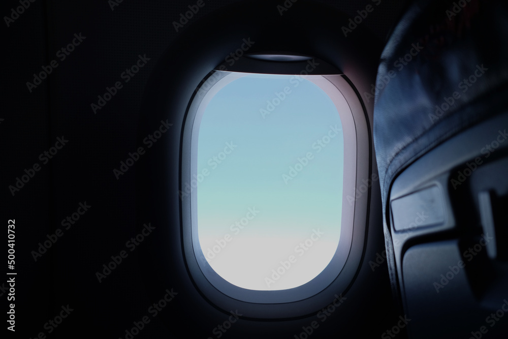 airplane window with blue sky outside
