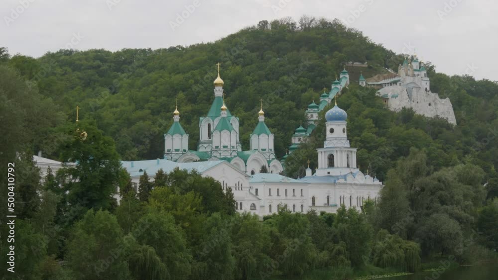 Svyatogorsk Lavra, Donetsk region, Ukraine. A beautiful old monastery is located in the valley of the Seversky Donets River on a mountain around the green foliage of trees Svyatogorsk Lavra, Donetsk region, Ukraine. A beautiful old monastery is located in the valley of the Seversky Donets River on a mountain around the green foliage of trees