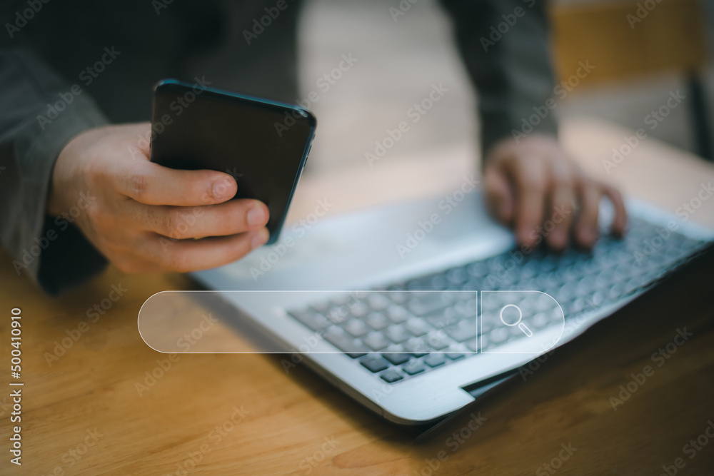 Search technology, search engine optimization,man's hand using laptop computer keyboard to search information,using search engine bar function on your website.People who work in cafes