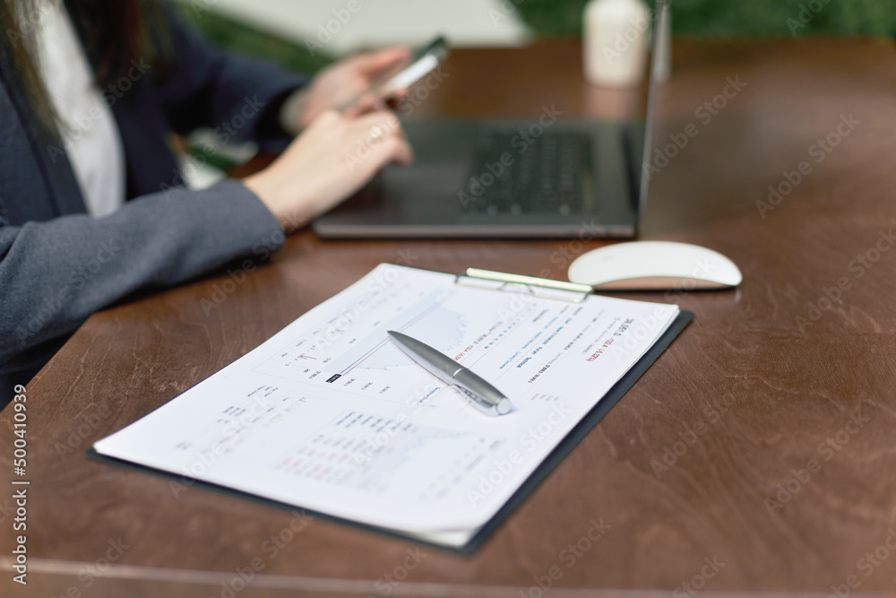 folder with documents on the desk of a business woman. close-up. folder with documents on the desk of a business woman. close-up.