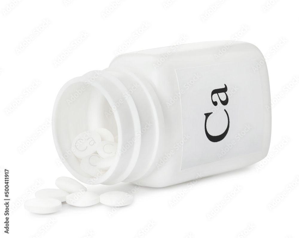 Overturned bottle of calcium supplement pills on white background