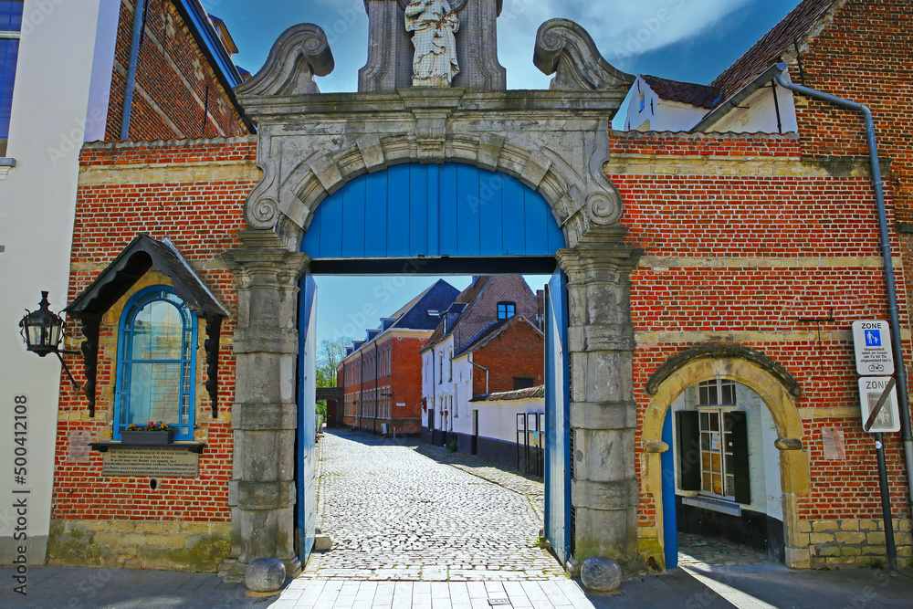 Lier (Begijnhof), Belgium - April 9. 2022: View on red brick stone entrance gate of medieval belgian unesco world heritage site village