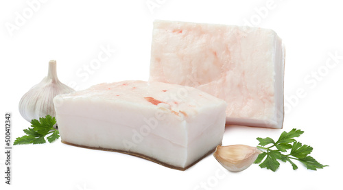 Pieces of pork fatback with garlic and parsley on white background