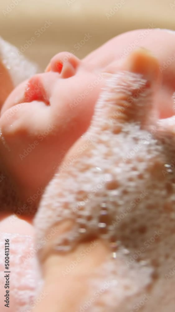 Mother giving her baby boy a bath in bathroom 4k Mother giving her baby boy a bath in bathroom 4k