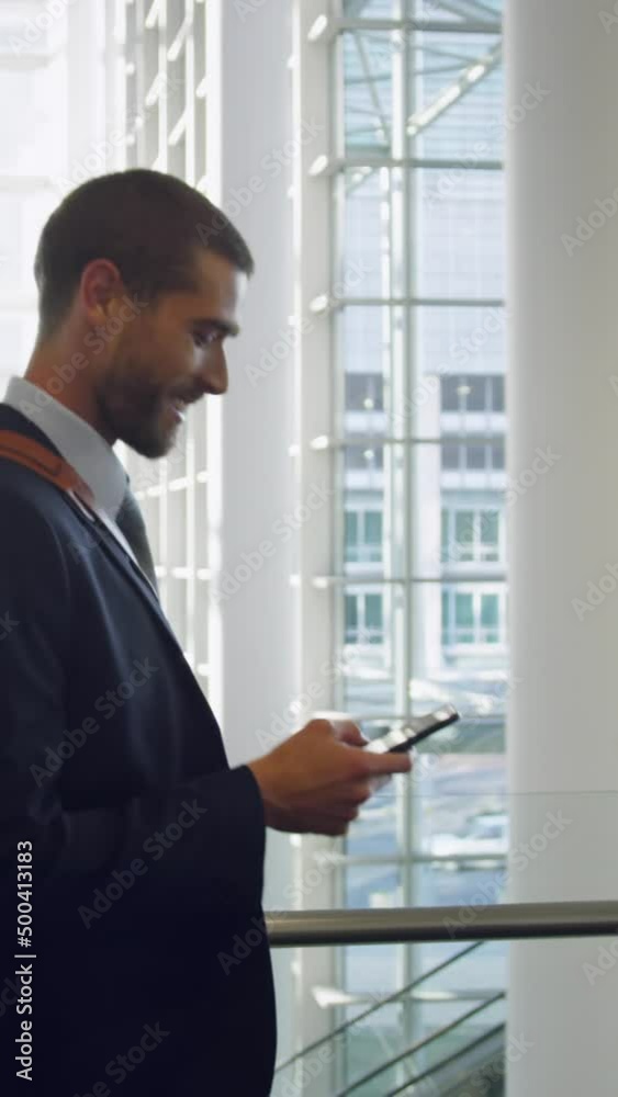 Businessman talking on mobile phone in the lobby at office 4k Businessman talking on mobile phone in the lobby at office 4k