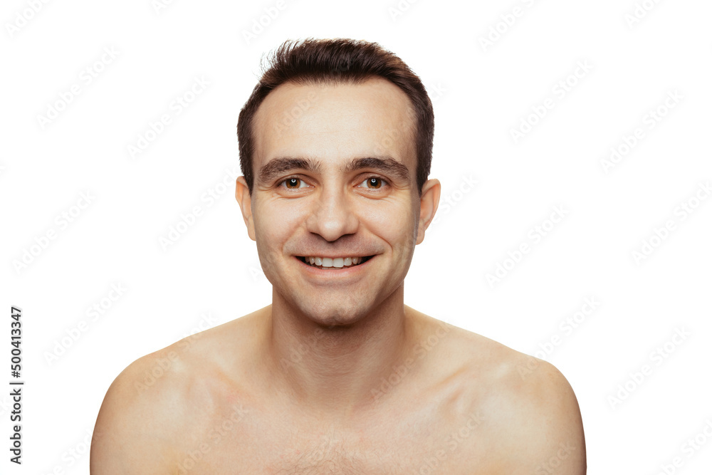 Portrait of smiling young man with perfect smooth shaved face posing isolated over white studio background. Natural male beauty Portrait of smiling young man with perfect smooth shaved face posing isolated over white studio background. Natural male beauty