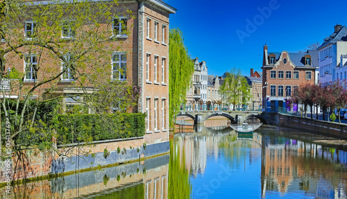 Beautiful belgian landscapes - View over scenic village water moat canal on ancient buildings, medieval stone arch bridge, clear blue sky, Lier, Belgium